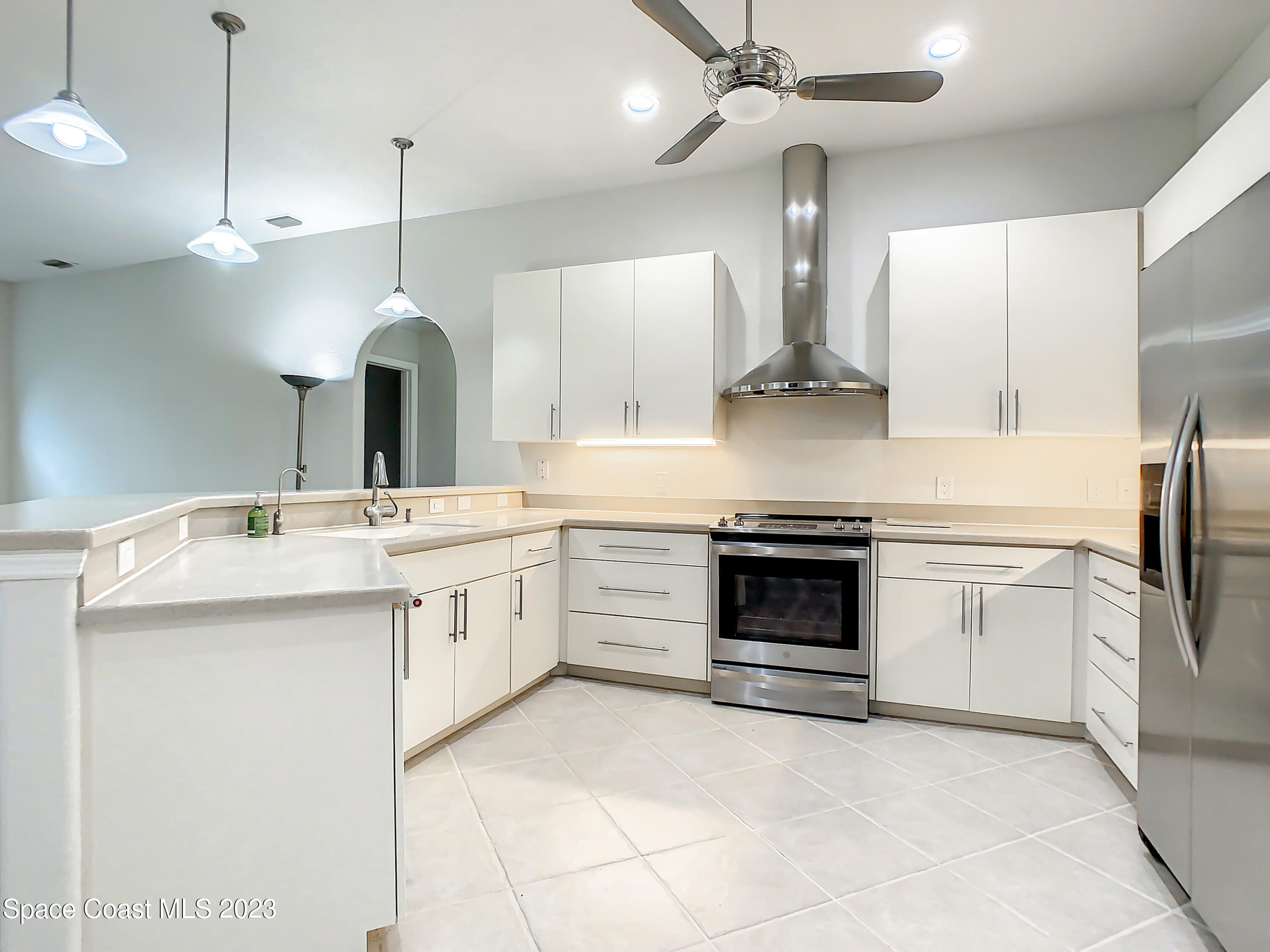 1965 Gates Road Merritt Island, FL 32952 - Photo 12 of 54 a kitchen with a stove oven and kitchen island