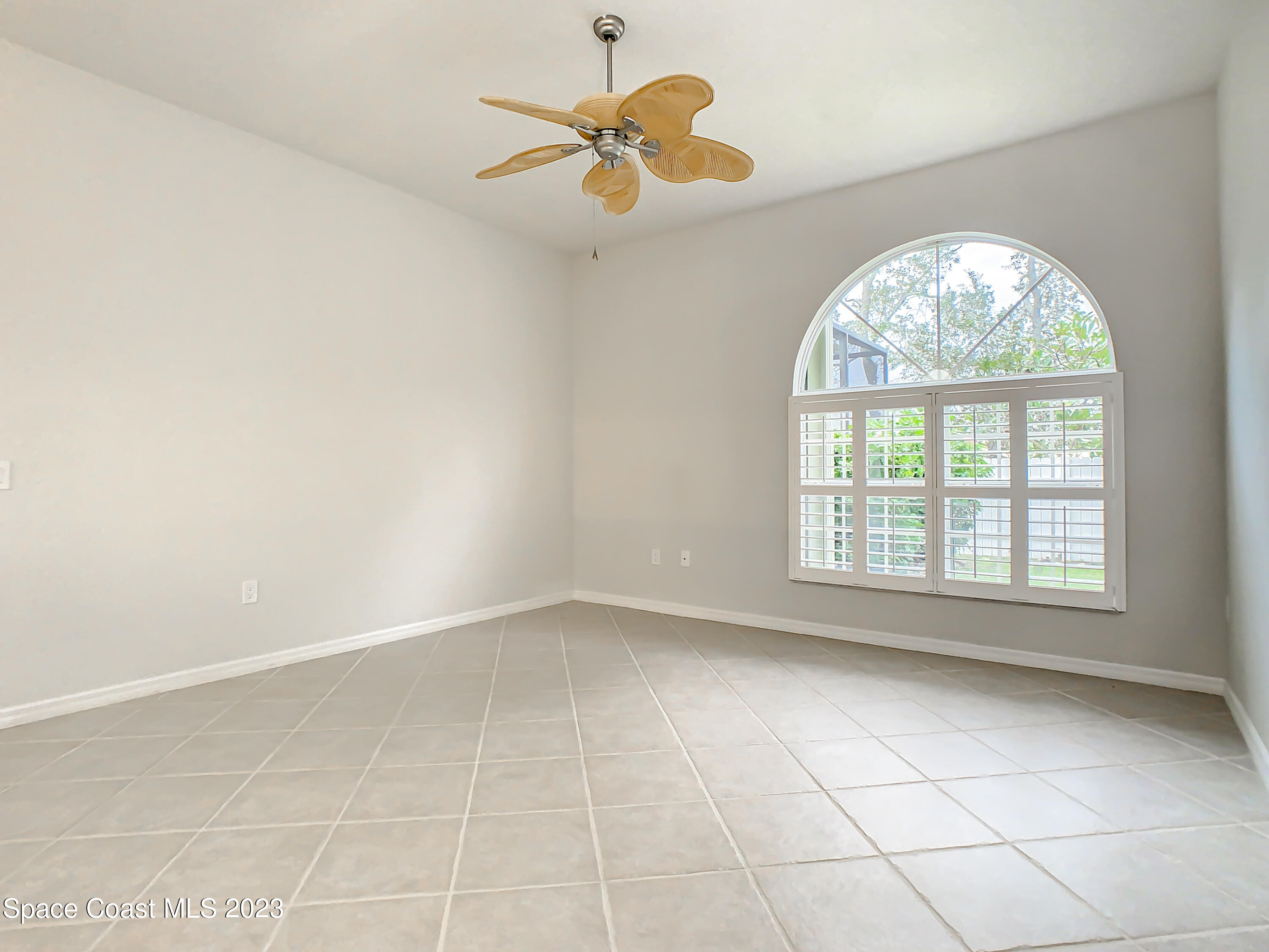 1965 Gates Road Merritt Island, FL 32952 - Photo 18 of 54 an empty room with a window and a fan