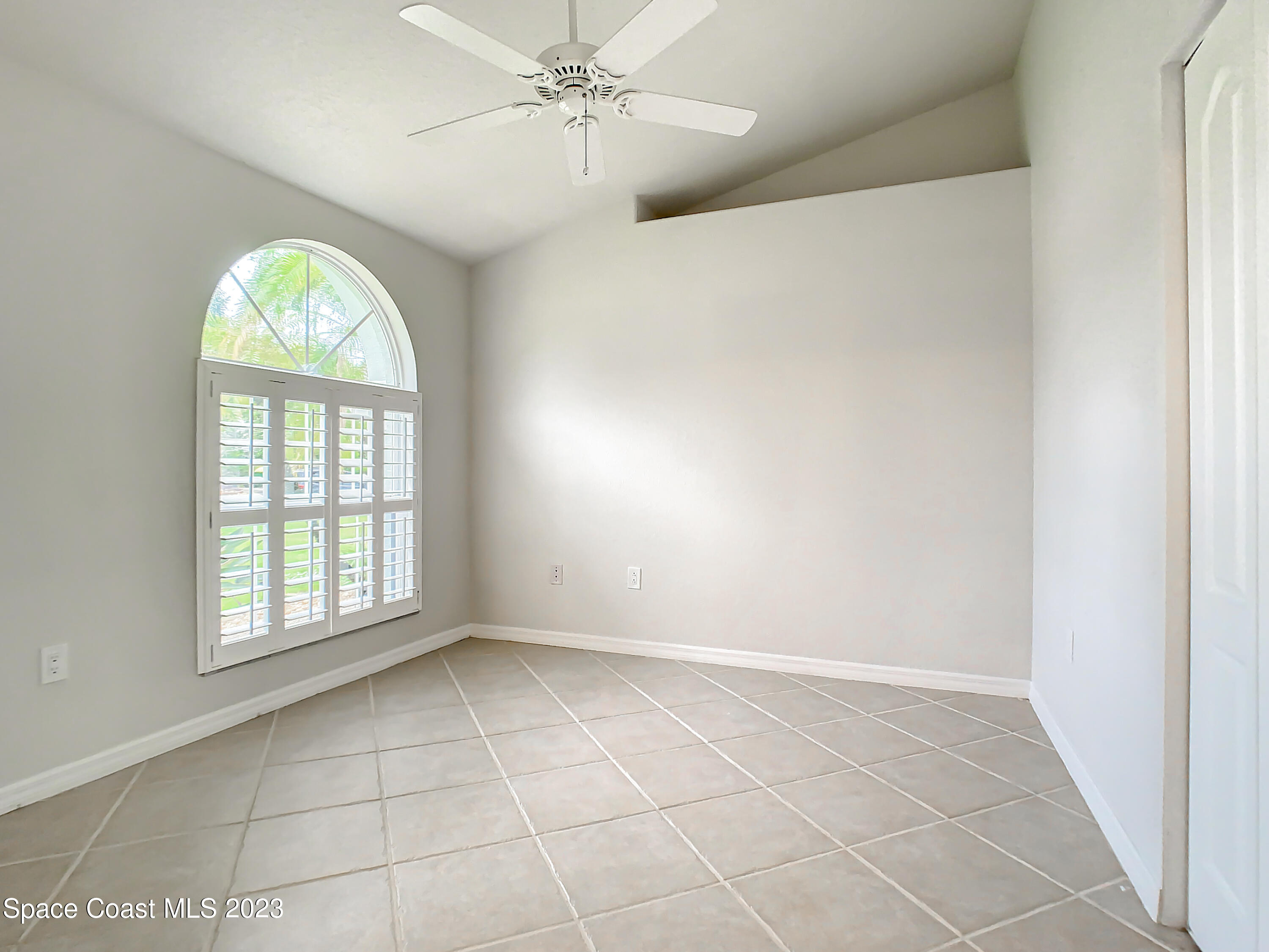 1965 Gates Road Merritt Island, FL 32952 - Photo 20 of 54 an empty room with windows and fan