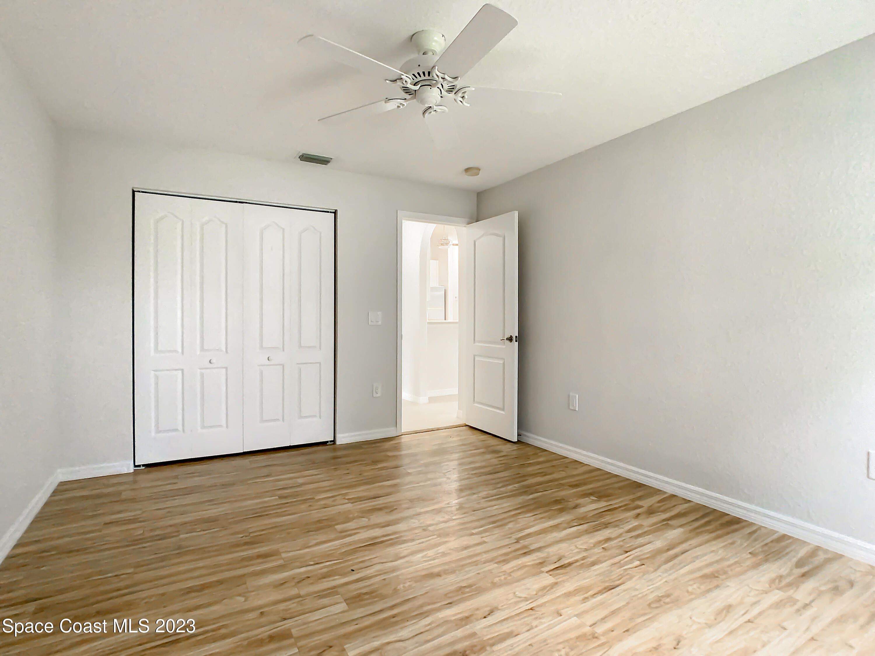 1965 Gates Road Merritt Island, FL 32952 - Photo 21 of 54 a view of an empty room with wooden floor
