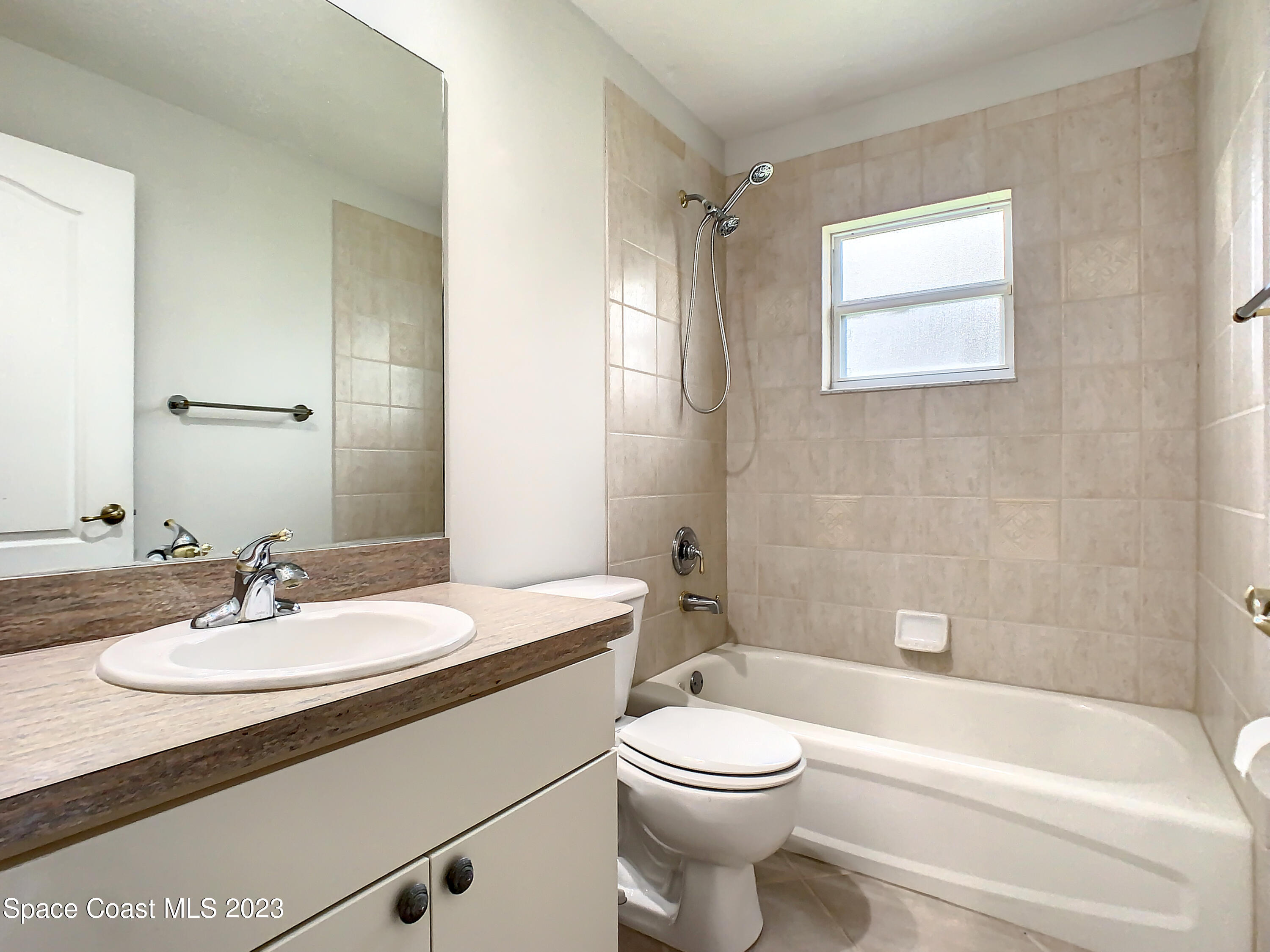 1965 Gates Road Merritt Island, FL 32952 - Photo 23 of 54 a bathroom with a sink a toilet and shower