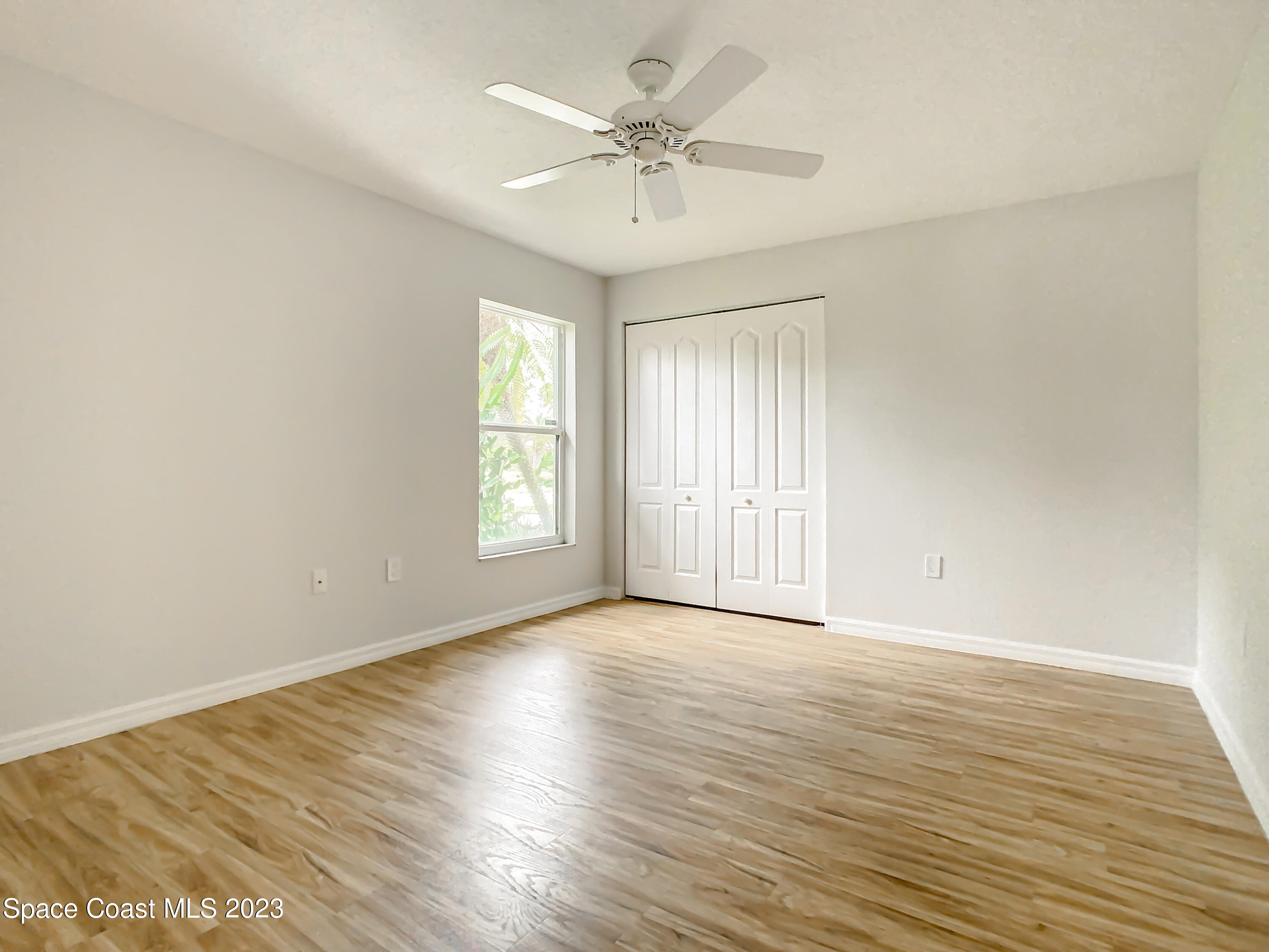 1965 Gates Road Merritt Island, FL 32952 - Photo 26 of 54 wooden floor in an empty room with a window