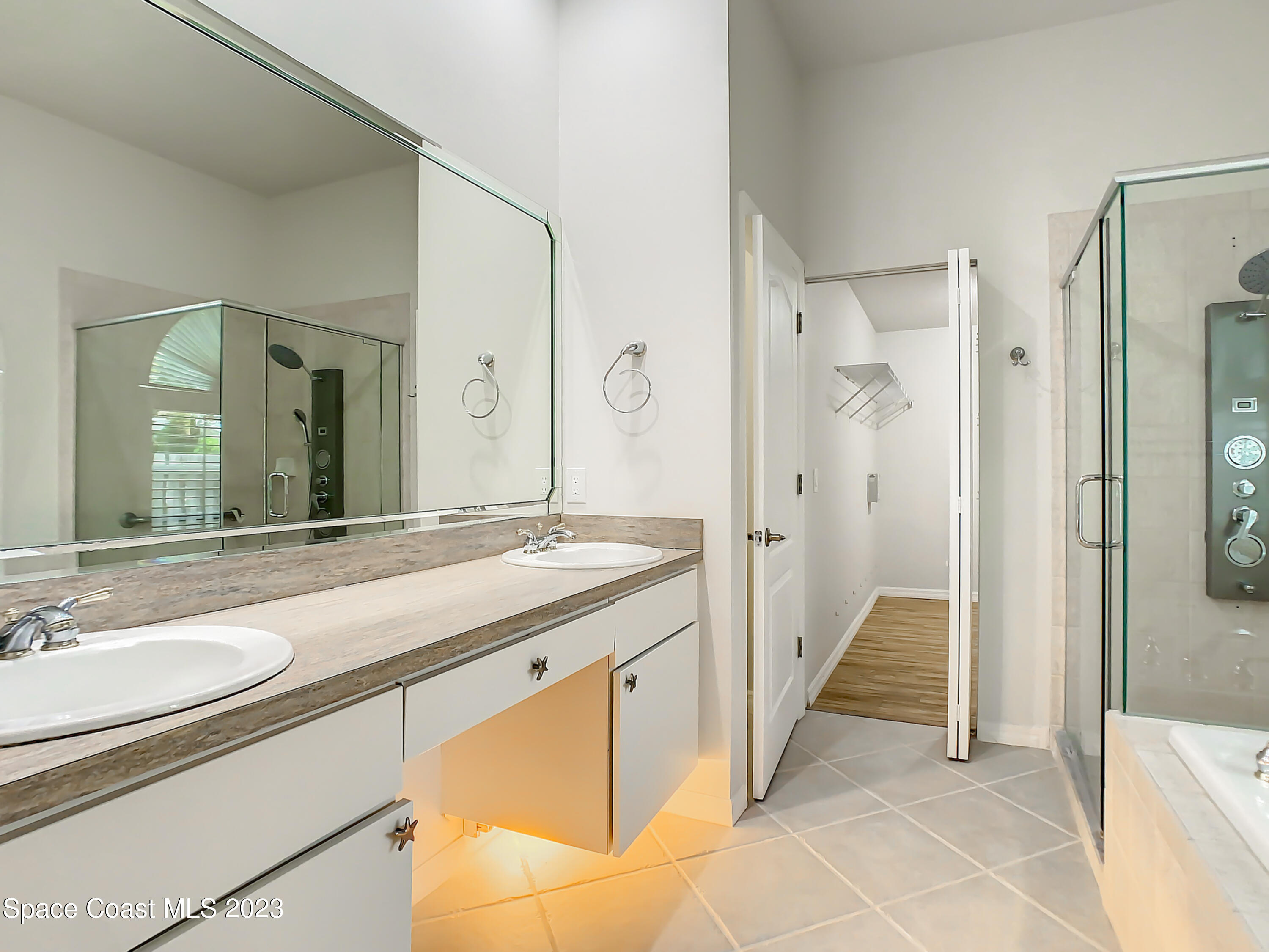 1965 Gates Road Merritt Island, FL 32952 - Photo 30 of 54 a bathroom with a granite countertop sink mirror and a bathtub