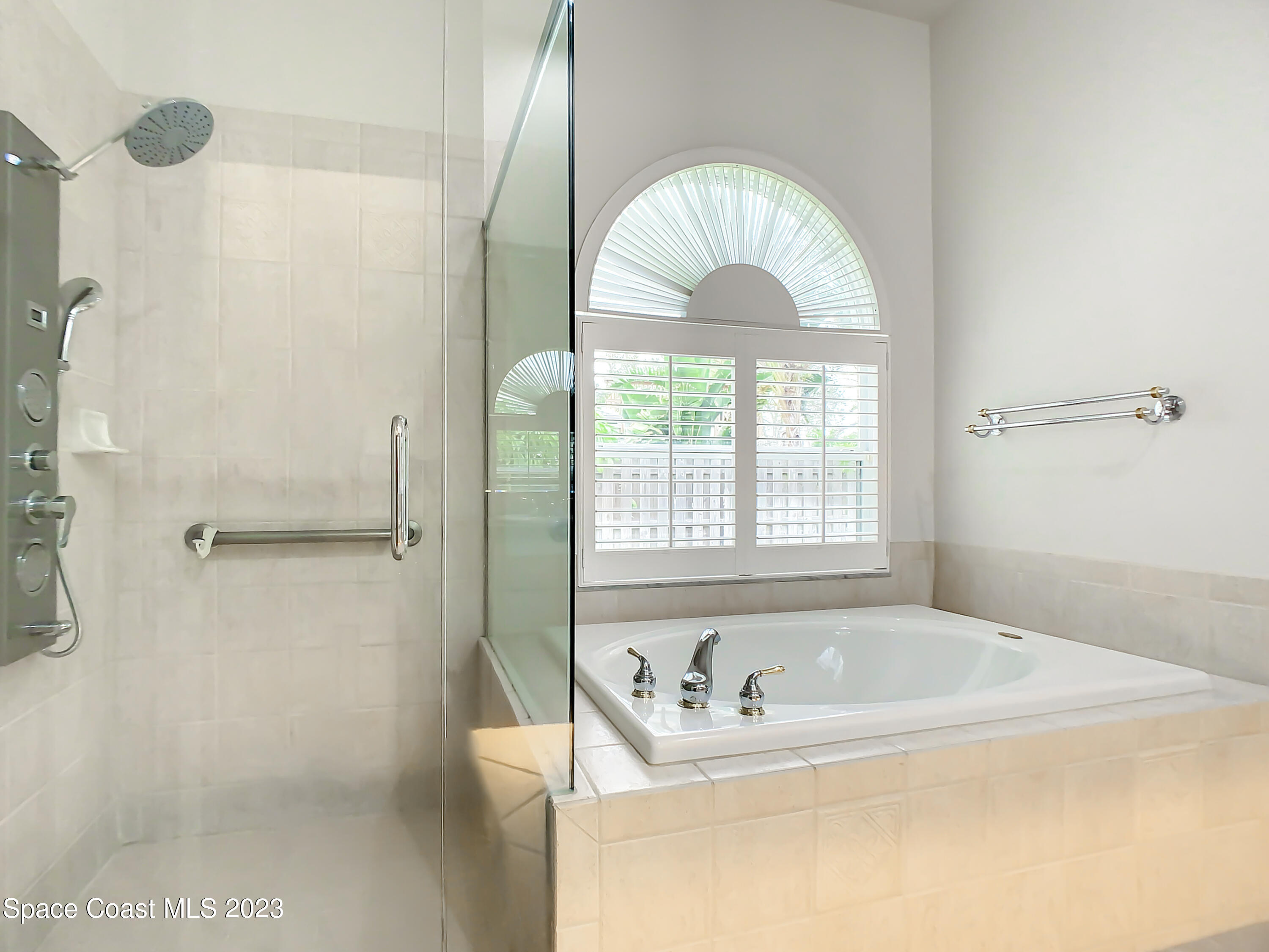 1965 Gates Road Merritt Island, FL 32952 - Photo 31 of 54 a bathroom with a tub a sink and window