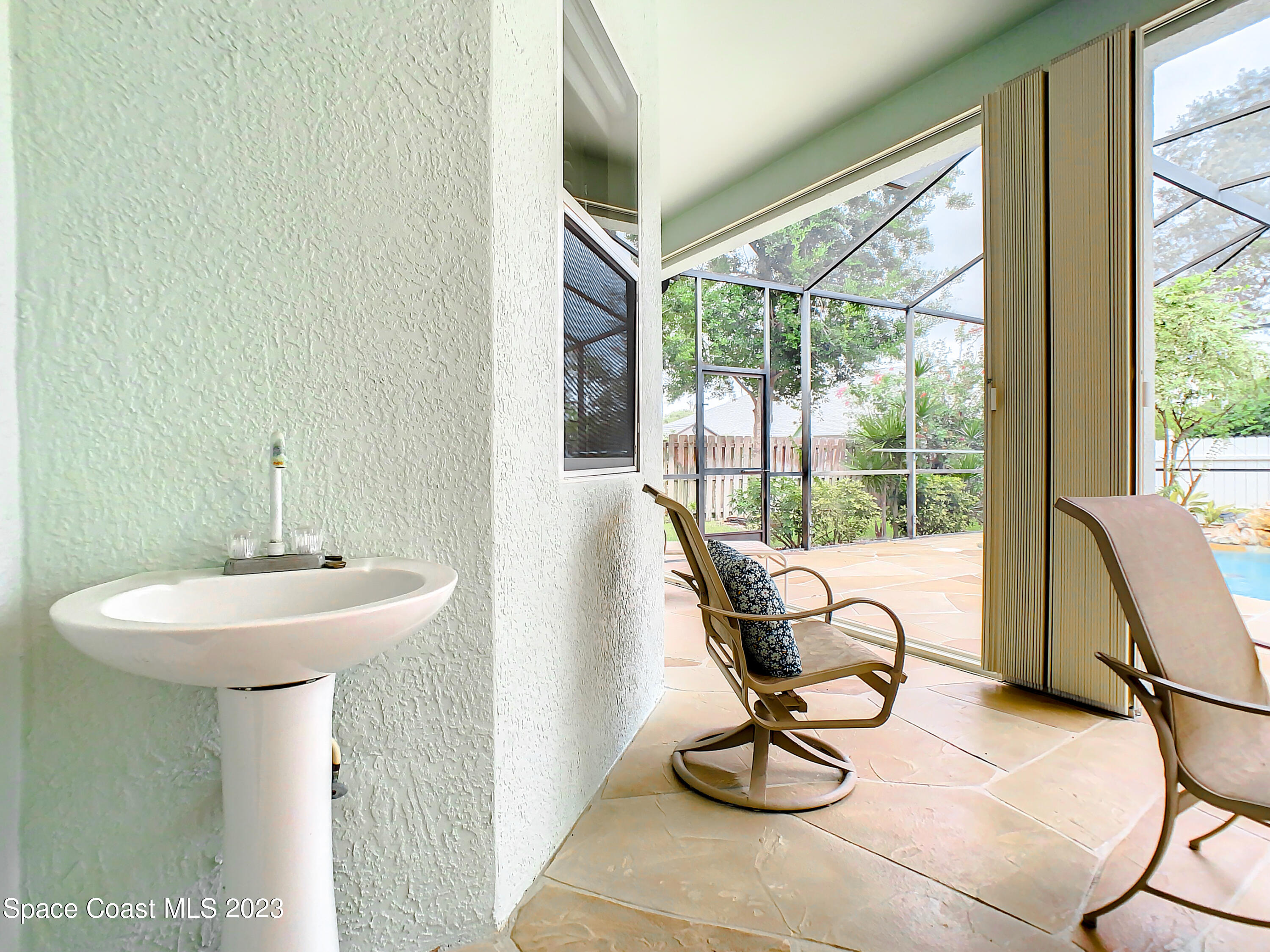 1965 Gates Road Merritt Island, FL 32952 - Photo 33 of 54 a bathroom with a sink and mirror