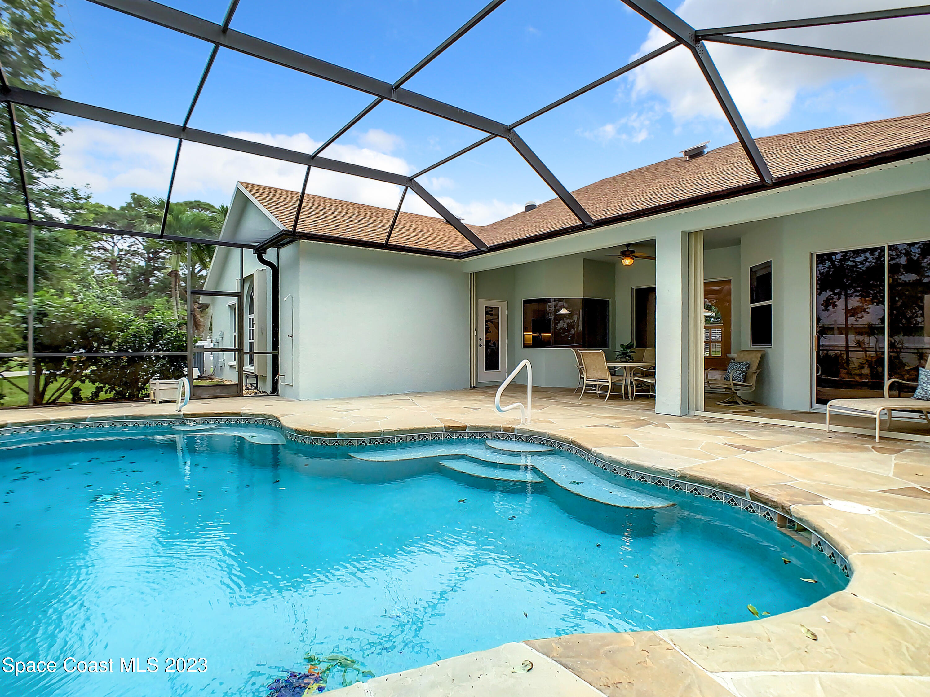 1965 Gates Road Merritt Island, FL 32952 - Photo 41 of 54 a swimming pool with outdoor seating and yard