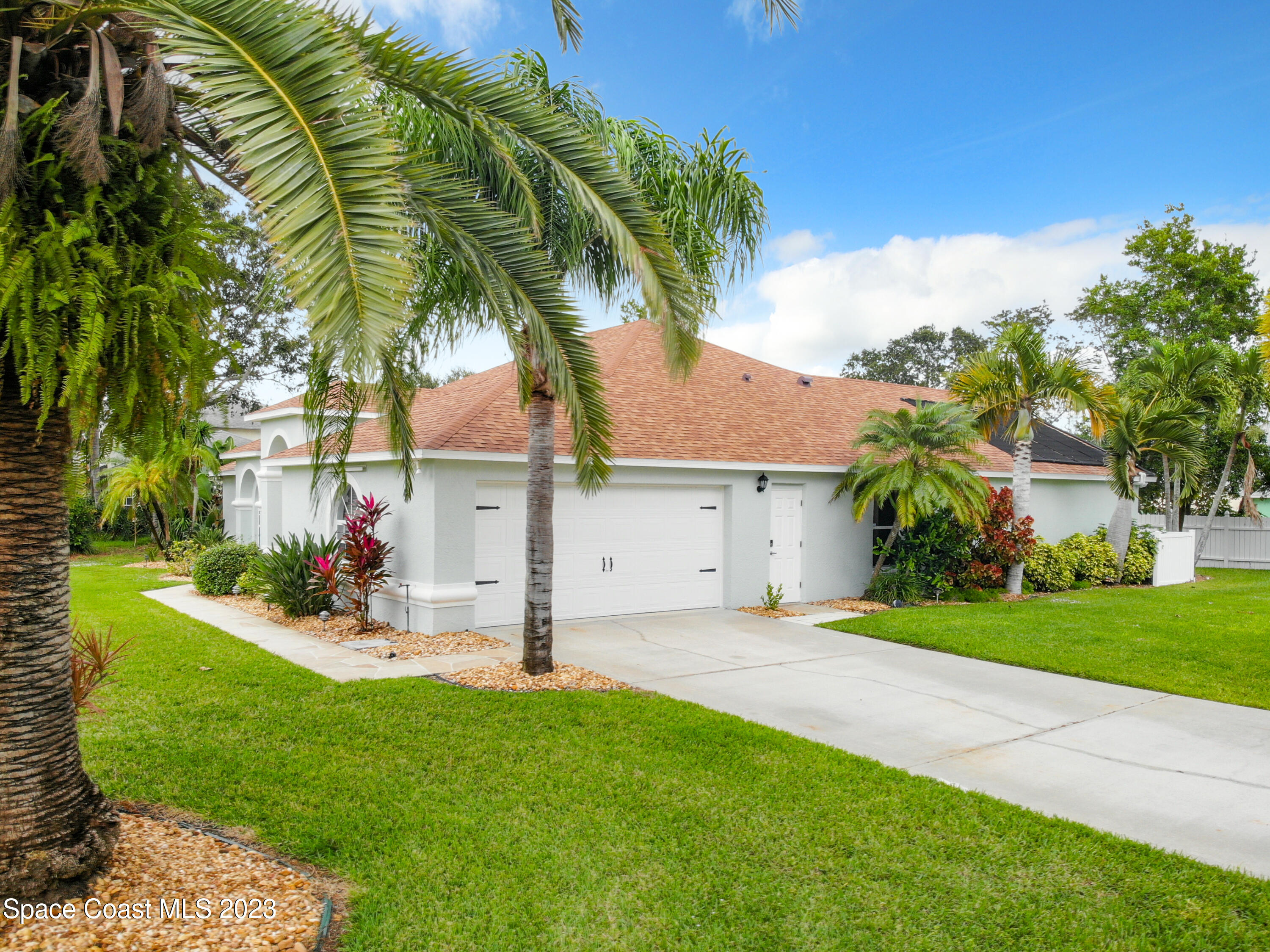1965 Gates Road Merritt Island, FL 32952 - Photo 44 of 54 a view of a house with a yard and palm trees