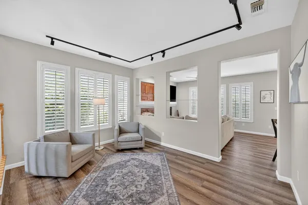 a view of empty room with wooden floor