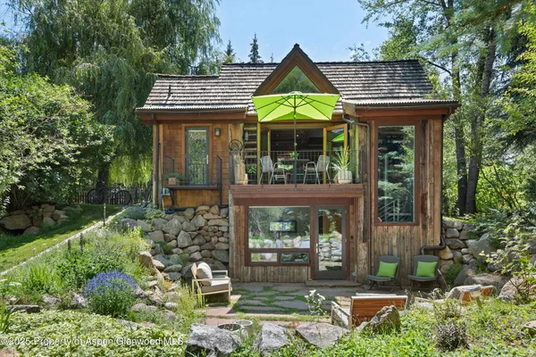a view of a chair and table in the patio and a backyard