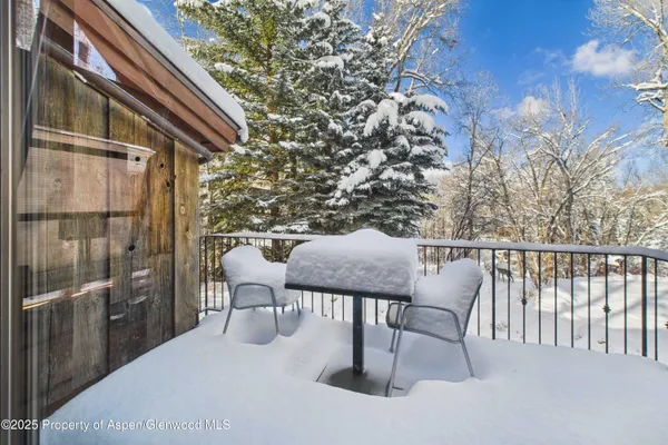 a view of balcony with a table and chairs