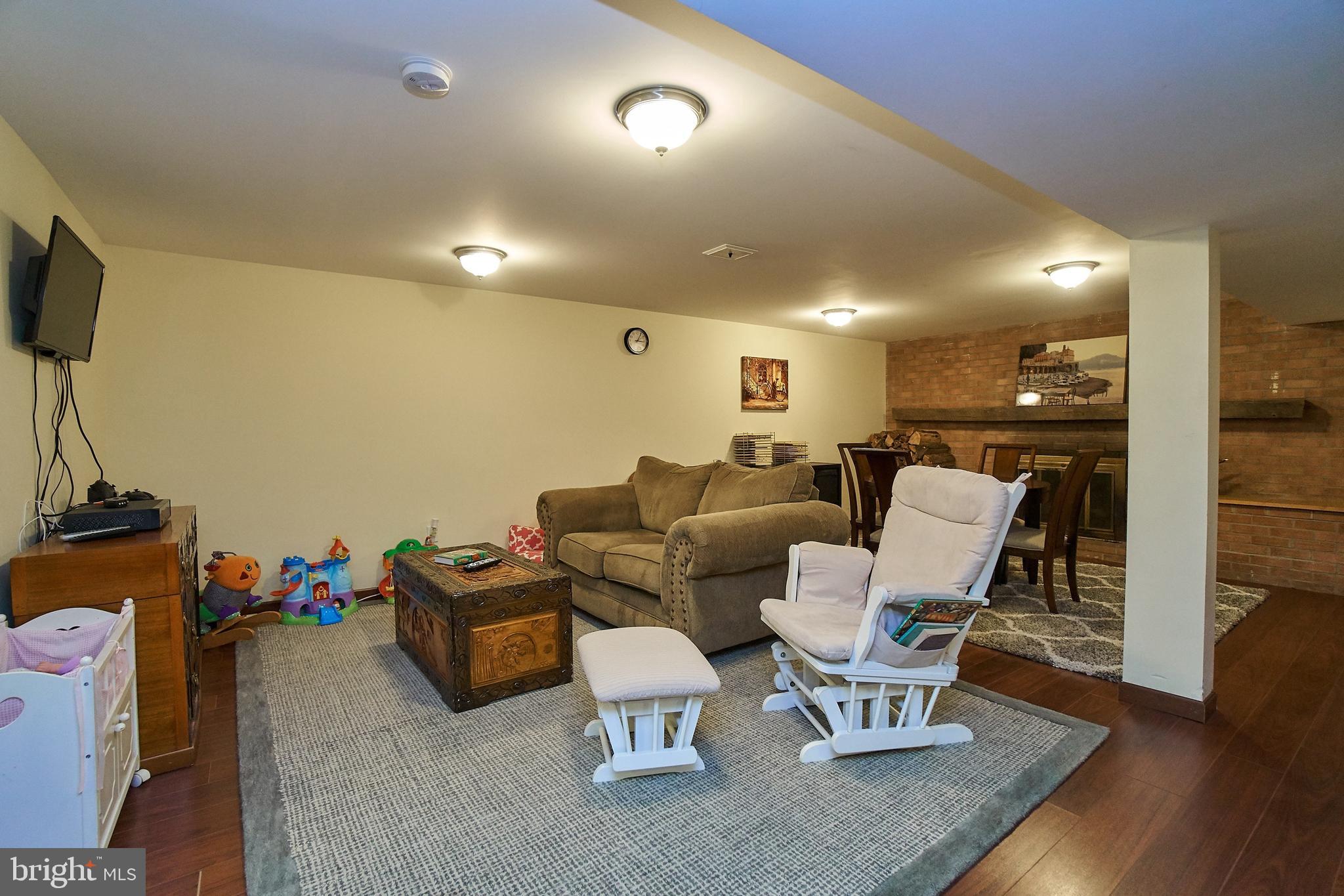 7300 Oriole Avenue Springfield, VA 22150 - Photo 22 of 31 lower level family room with wood burning fireplac
