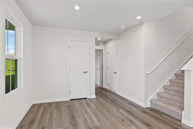 a view of an entryway with wooden floor