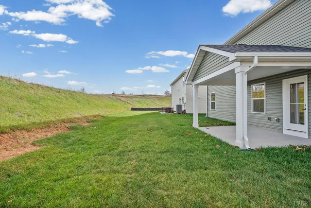 a view of a house with a yard and sitting area