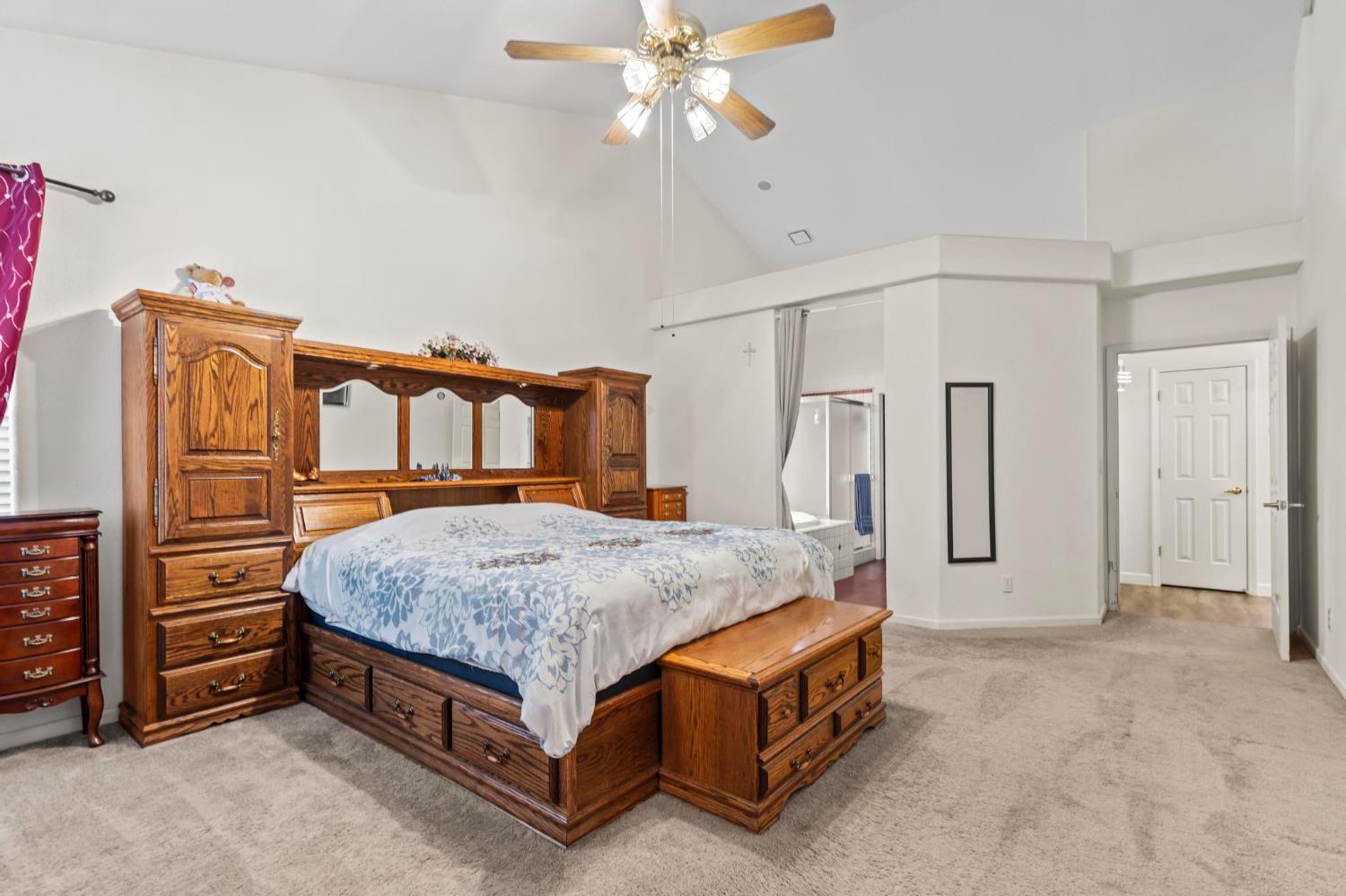 1090 Portola Valley Road Yuba City, CA 95993 - Photo 11 of 42 a spacious bedroom with a bed and a chandelier