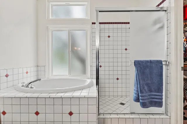 a bathroom with a bathtub and shower