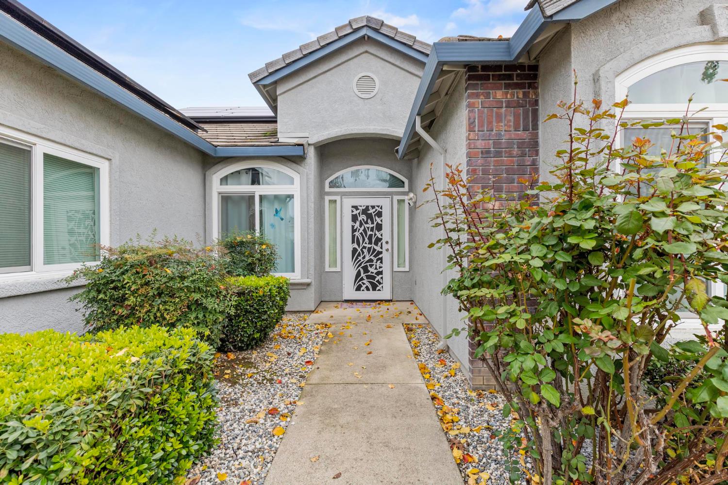 1090 Portola Valley Road Yuba City, CA 95993 - Photo 2 of 42 a view of a brick house with large windows