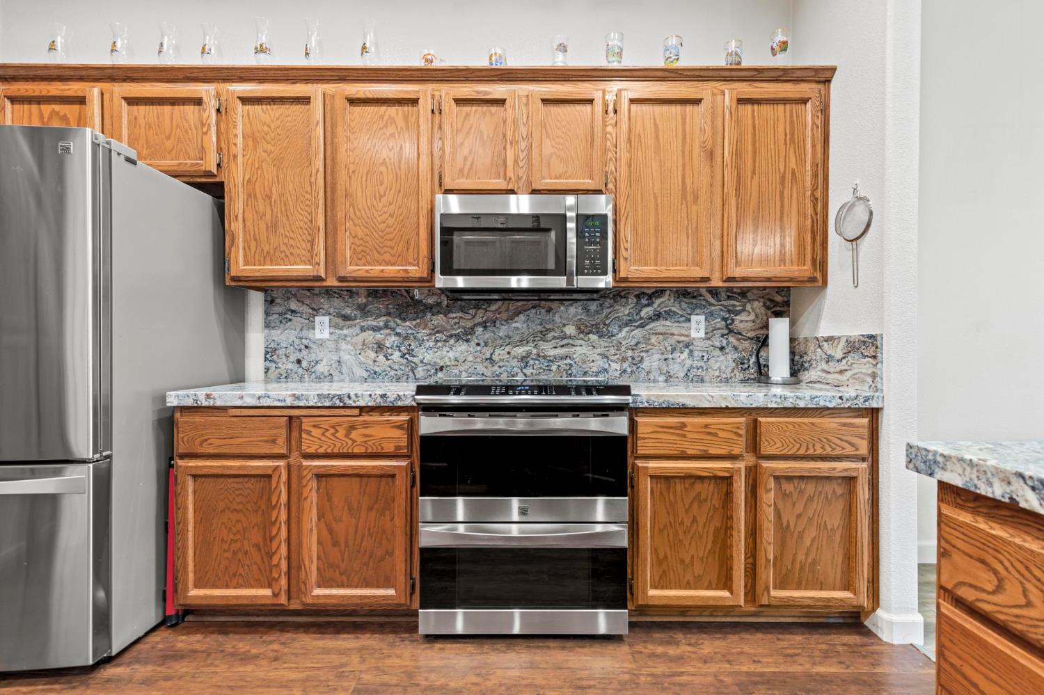 1090 Portola Valley Road Yuba City, CA 95993 - Photo 23 of 42 a kitchen with stainless steel appliances a stove and a microwave