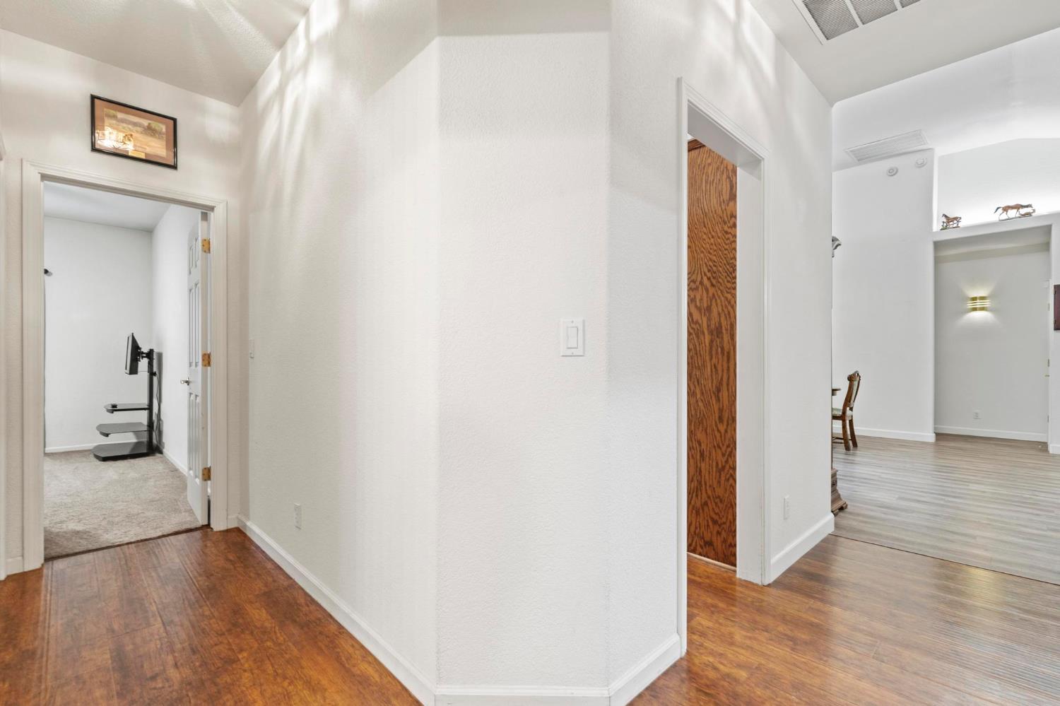 1090 Portola Valley Road Yuba City, CA 95993 - Photo 26 of 42 a view of a hallway with wooden floor and a living room