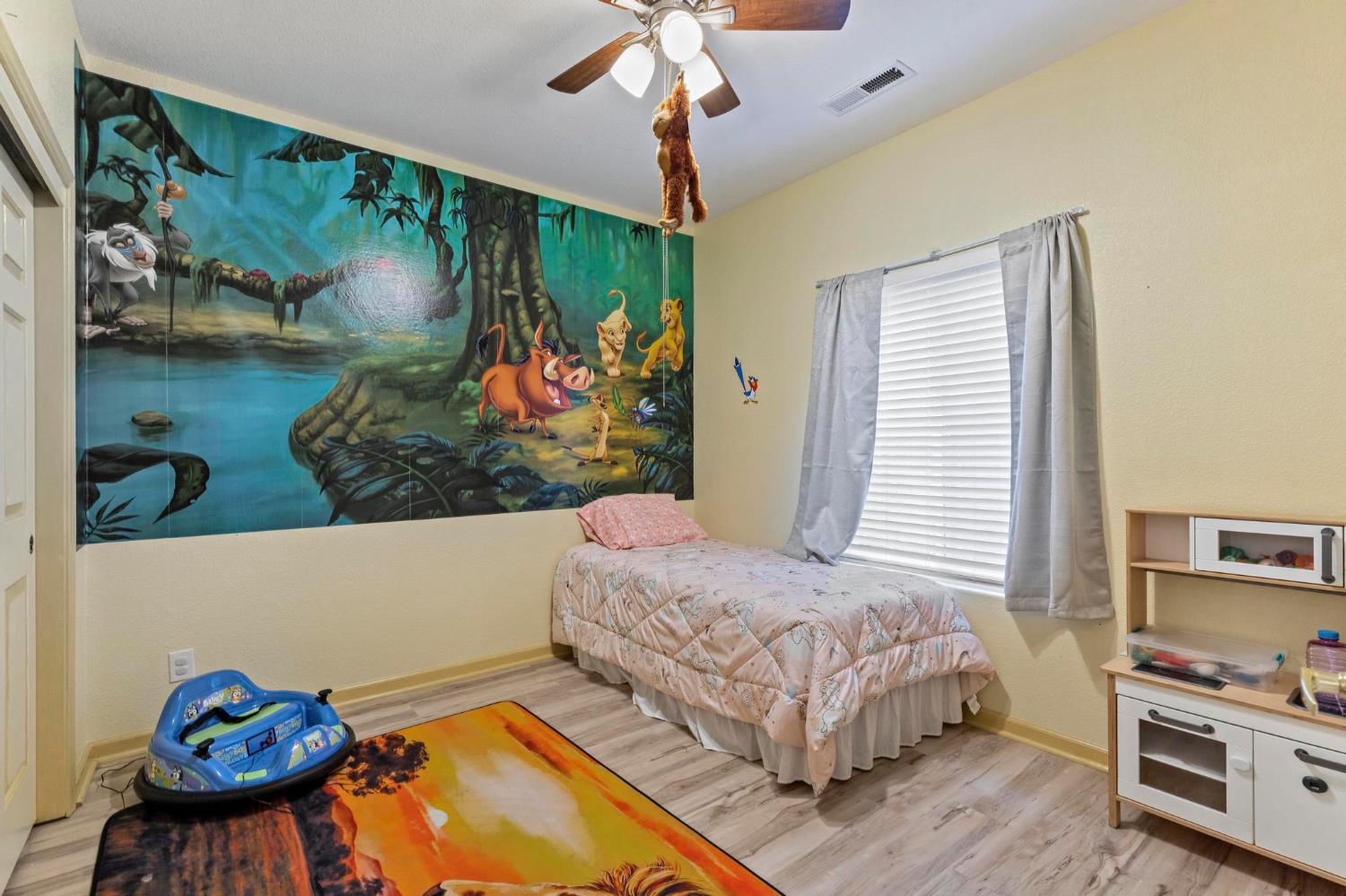 1090 Portola Valley Road Yuba City, CA 95993 - Photo 27 of 42 a bedroom with a bed and a chandelier