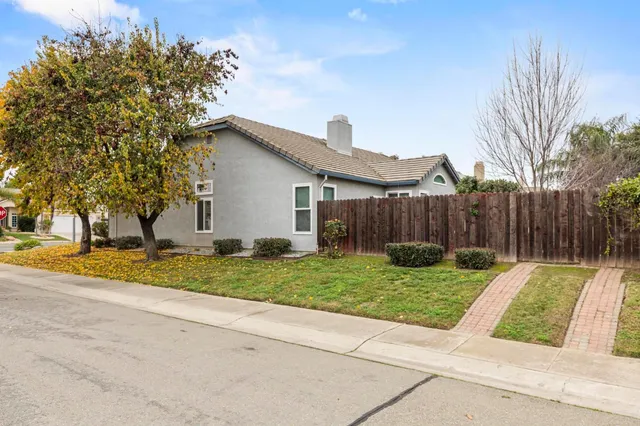 a view of backyard with wooden fence