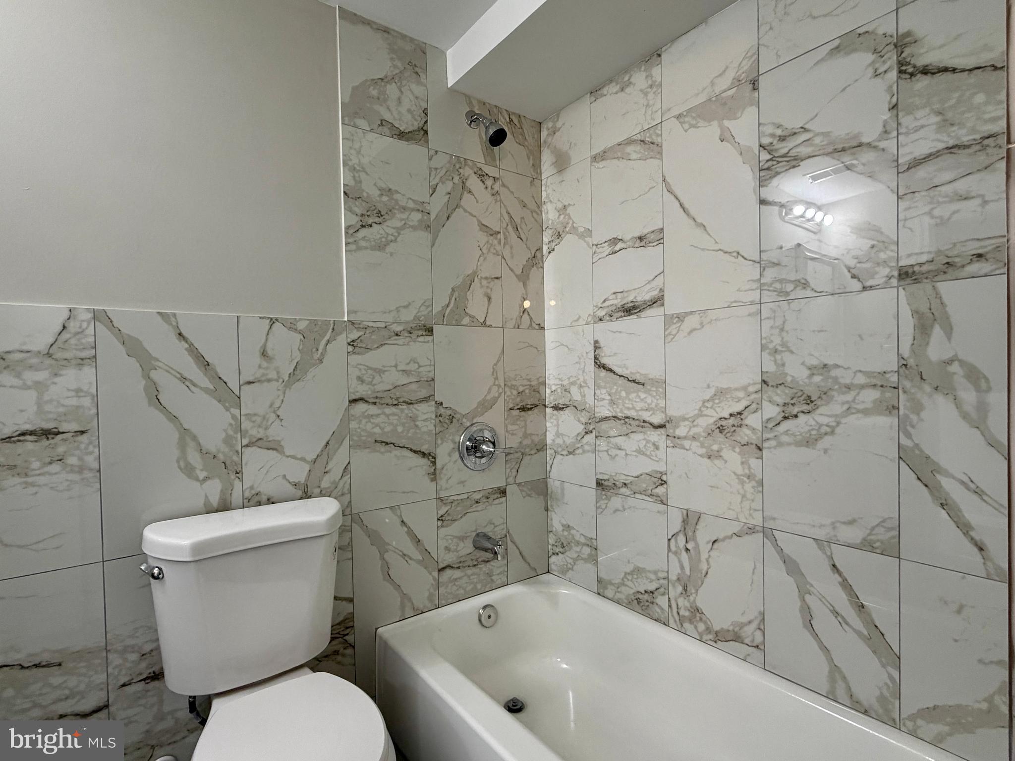 1727 Dallas Street, Unit 2 Philadelphia, PA 19126 - Photo 12 of 15 a bathroom with a toilet and a shower