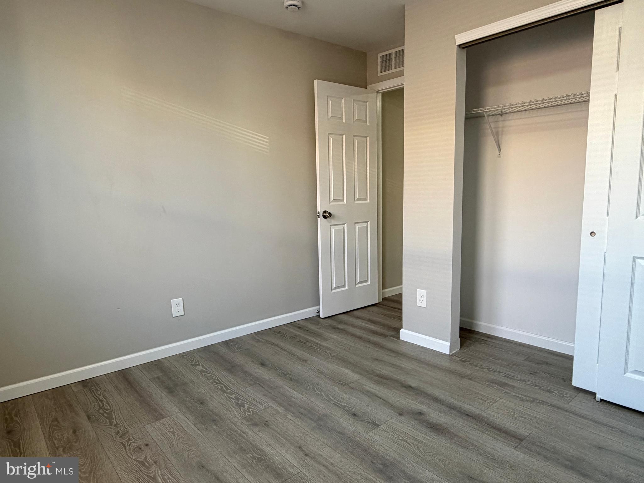 1727 Dallas Street, Unit 2 Philadelphia, PA 19126 - Photo 14 of 15 a view of an empty room with wooden floor and closet