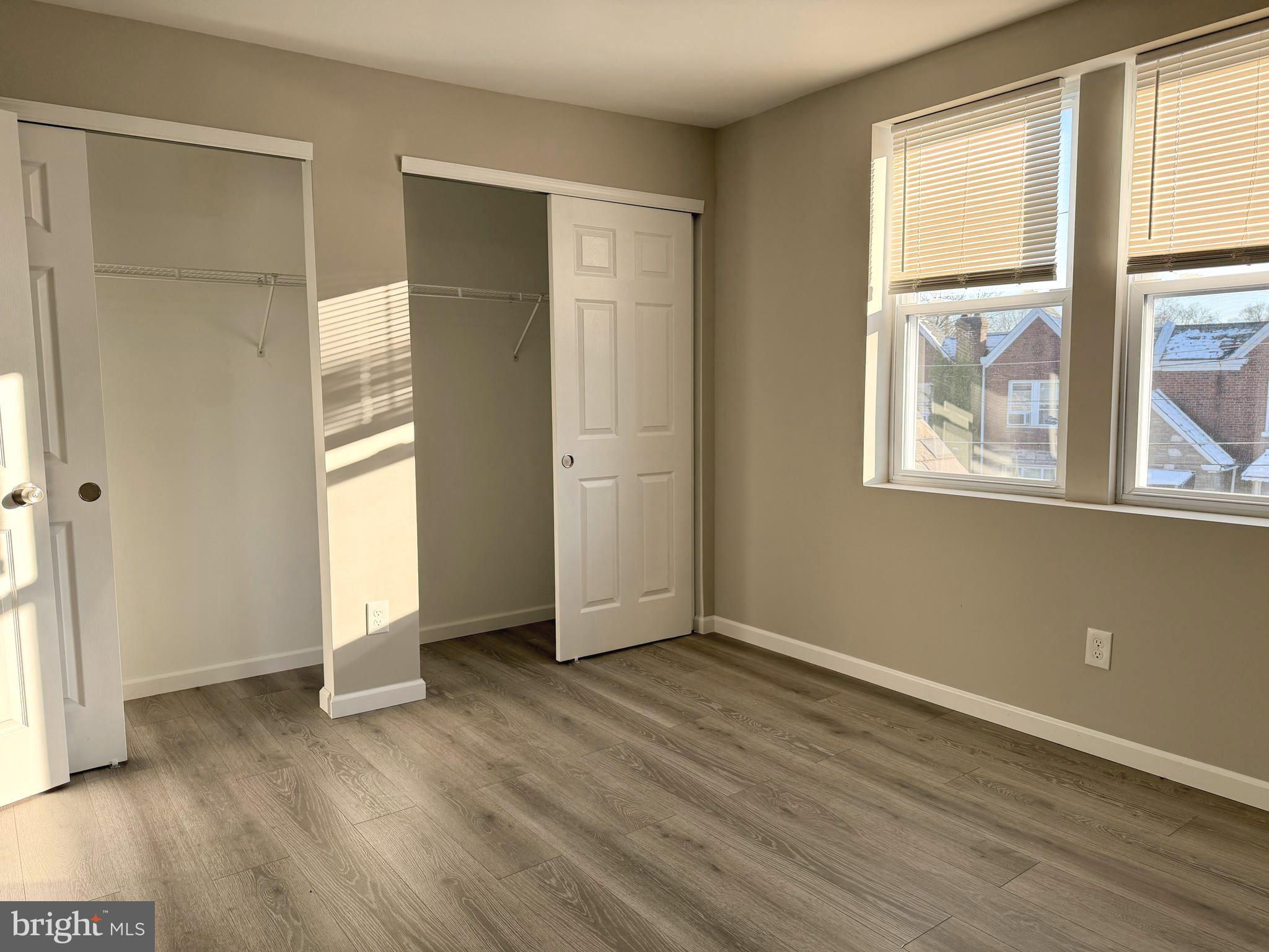 1727 Dallas Street, Unit 2 Philadelphia, PA 19126 - Photo 9 of 15 an empty room with wooden floor and windows