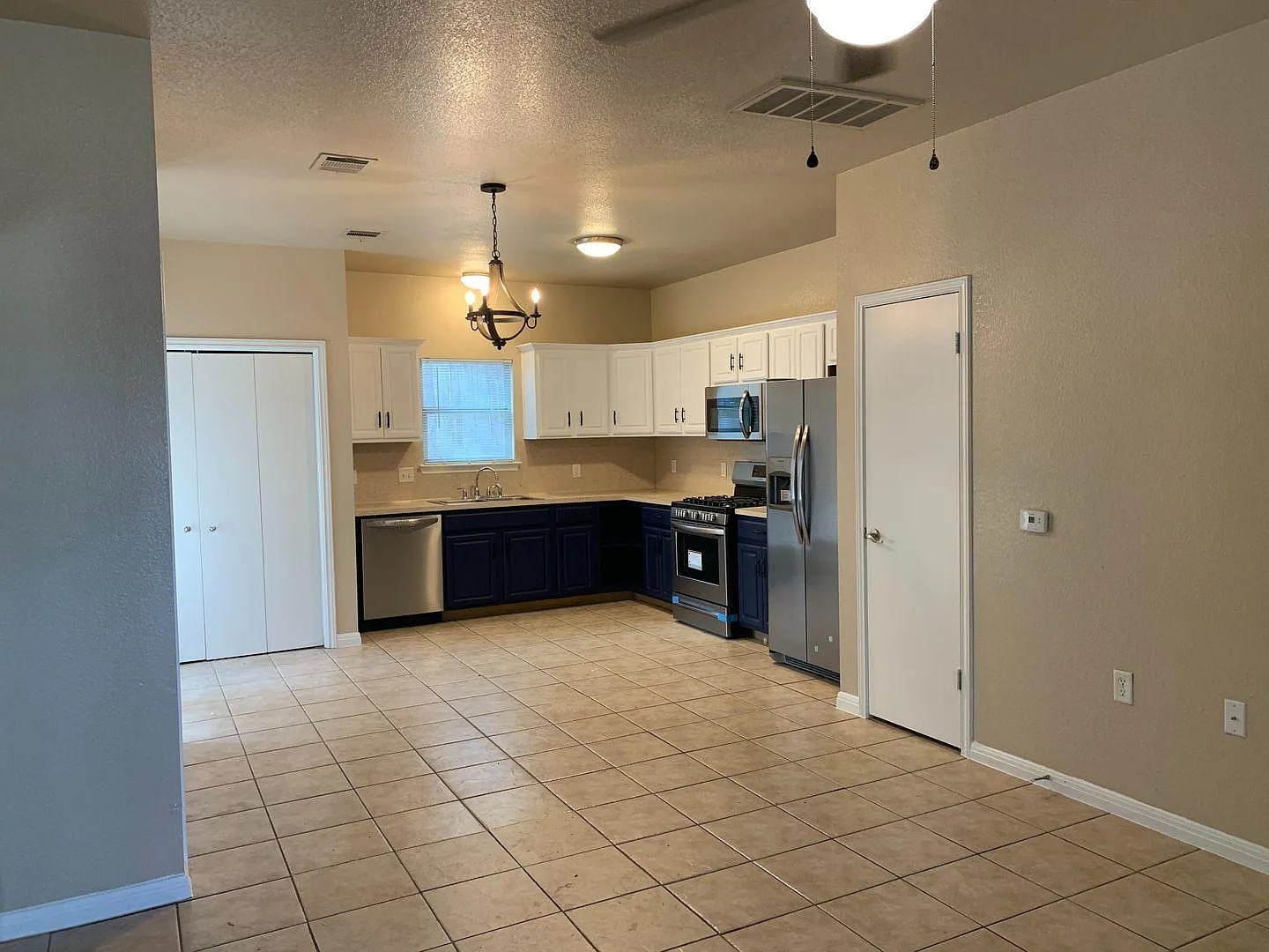 1812 Maple Avenue, Unit A Austin, TX 78702 - Photo 6 of 10 a large kitchen with cabinets and stainless steel appliances