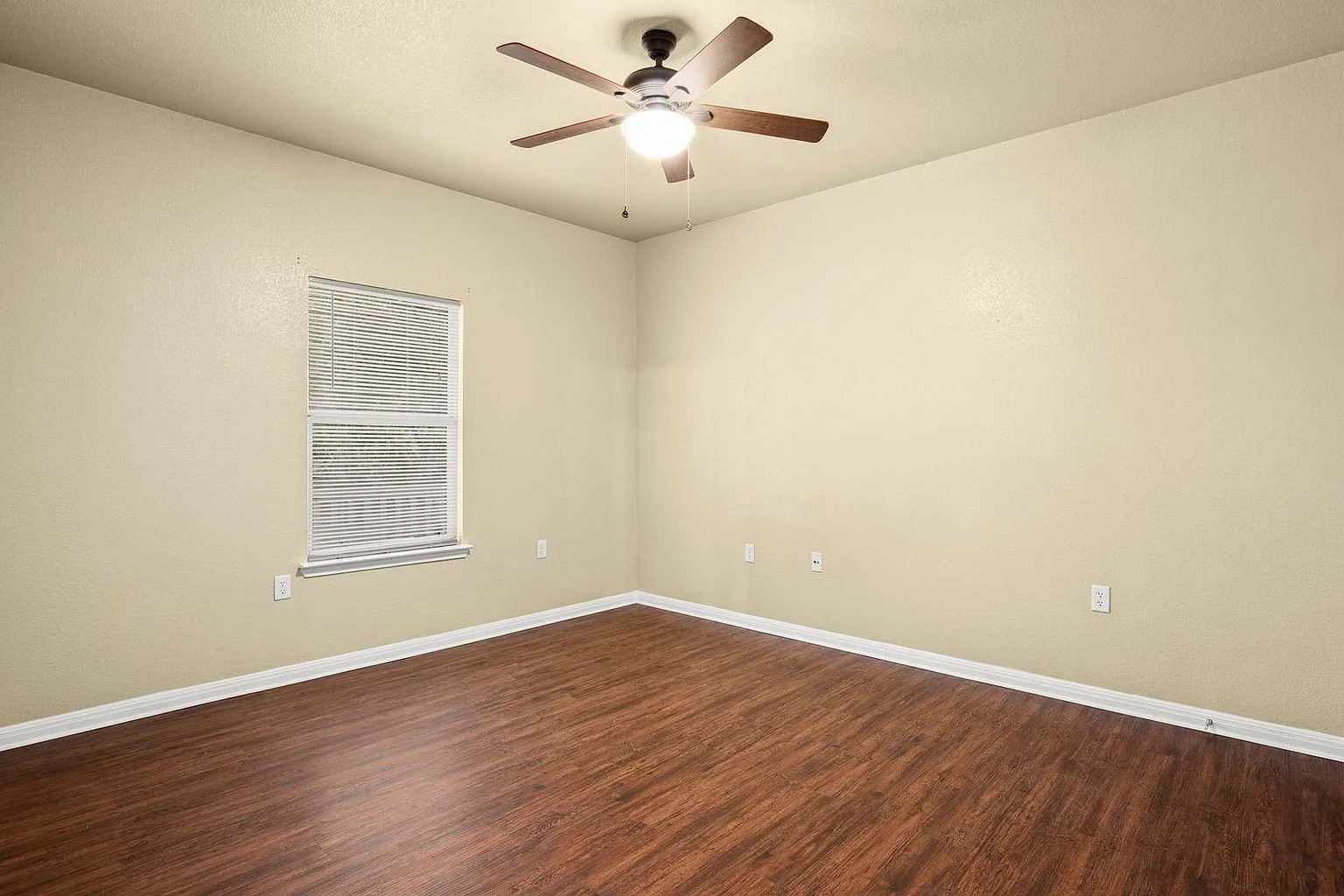 1812 Maple Avenue, Unit A Austin, TX 78702 - Photo 7 of 10 an empty room with wooden floor and windows