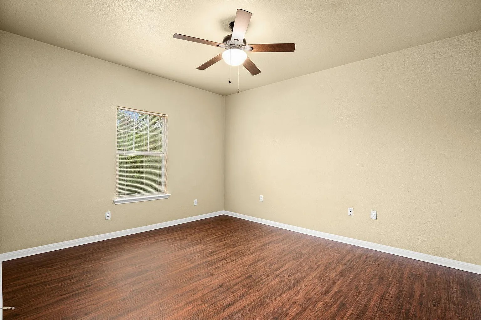 1812 Maple Avenue, Unit A Austin, TX 78702 - Photo 9 of 10 an empty room with wooden floor and windows