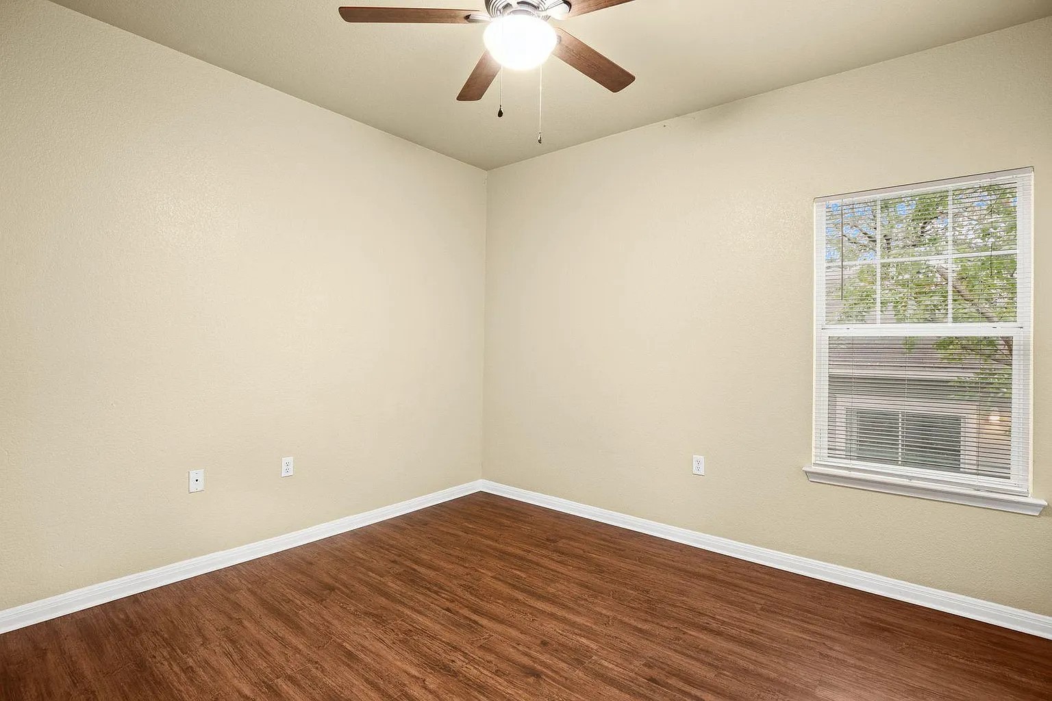 1812 Maple Avenue, Unit A Austin, TX 78702 - Photo 10 of 10 an empty room with wooden floor and windows
