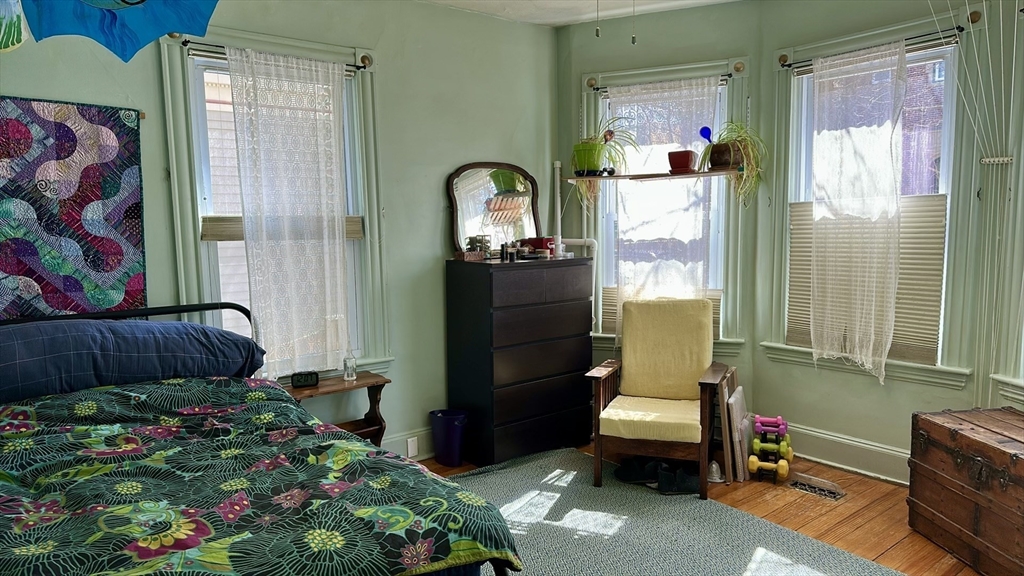81 Francis Street, Unit 2 Brookline, MA 02446 - Photo 2 of 9 a living room with a couch and a dining table