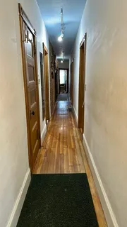 wooden floor in an empty room with a fireplace