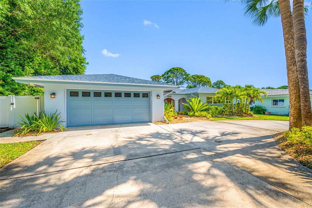 656 Mehlenbacher Road Belleair, FL 33756 - Photo 47 of 49 a front view of a house with a yard and garage