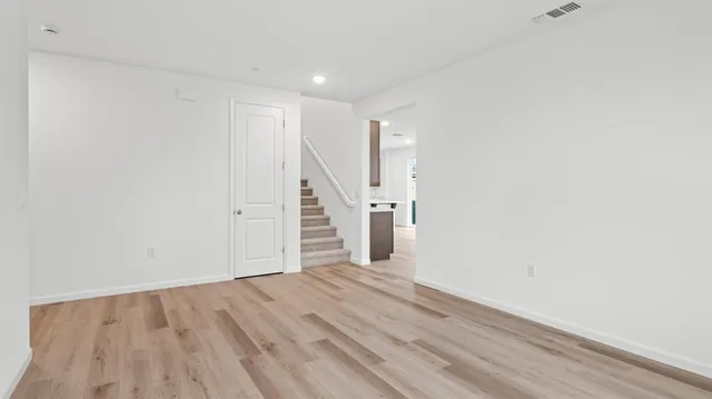 a view of a room with wooden floor and staircase