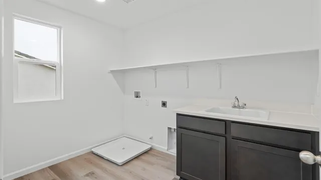 a room with a sink and cabinets