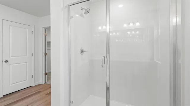 a bathroom with a glass shower door