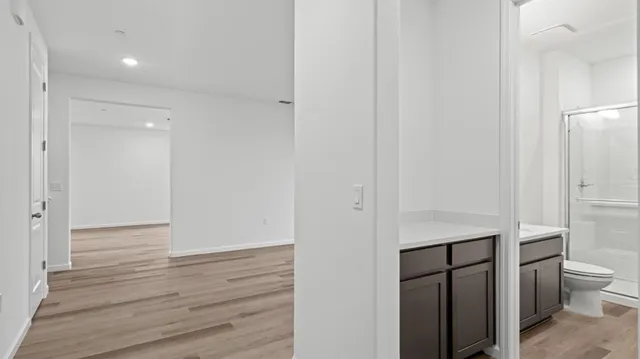 a view of bathroom with toilet shower vanity and a sink