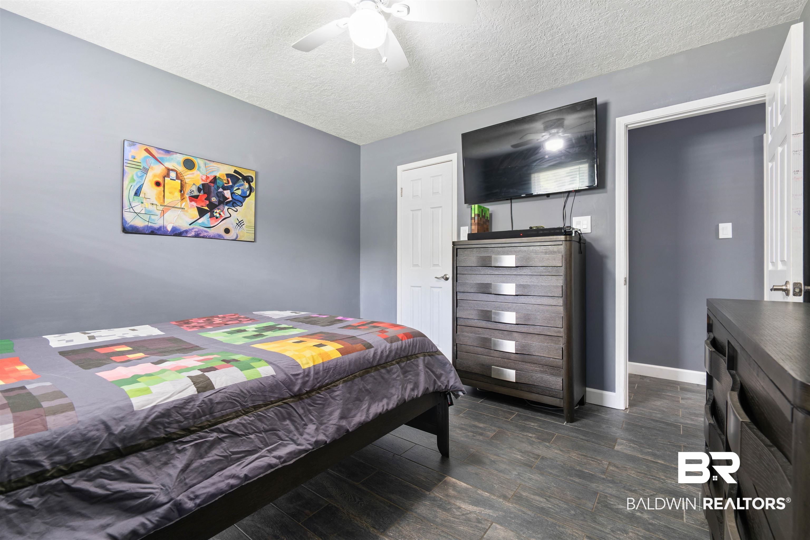 2000 Campfire Drive Semmes, AL 36575 - Photo 19 of 26 Bedroom with ceiling fan, a textured ceiling, and hardwood / wood-style flooring