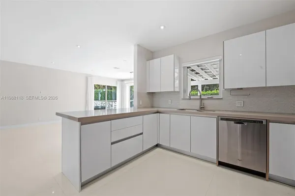 a kitchen with sink cabinets and window