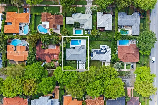 an aerial view of multiple houses with yard