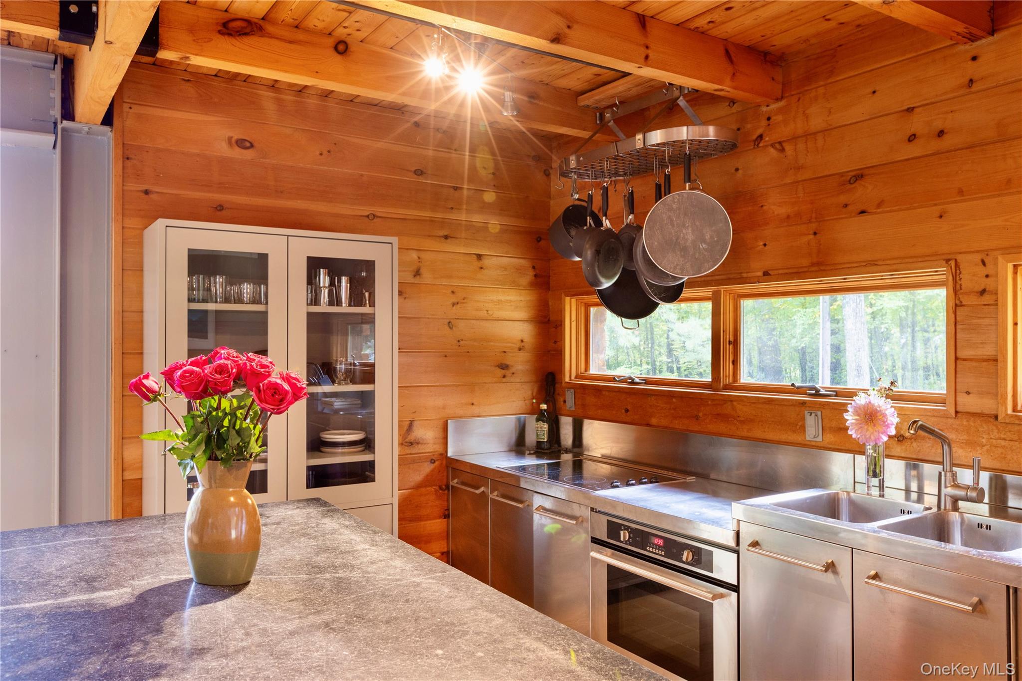 39 Hornbeck Road Accord, NY 12404 - Photo 9 of 24 Kitchen with stainless steel counters, oven, wood walls, black electric stovetop, and a wooden ceiling with exposed beams