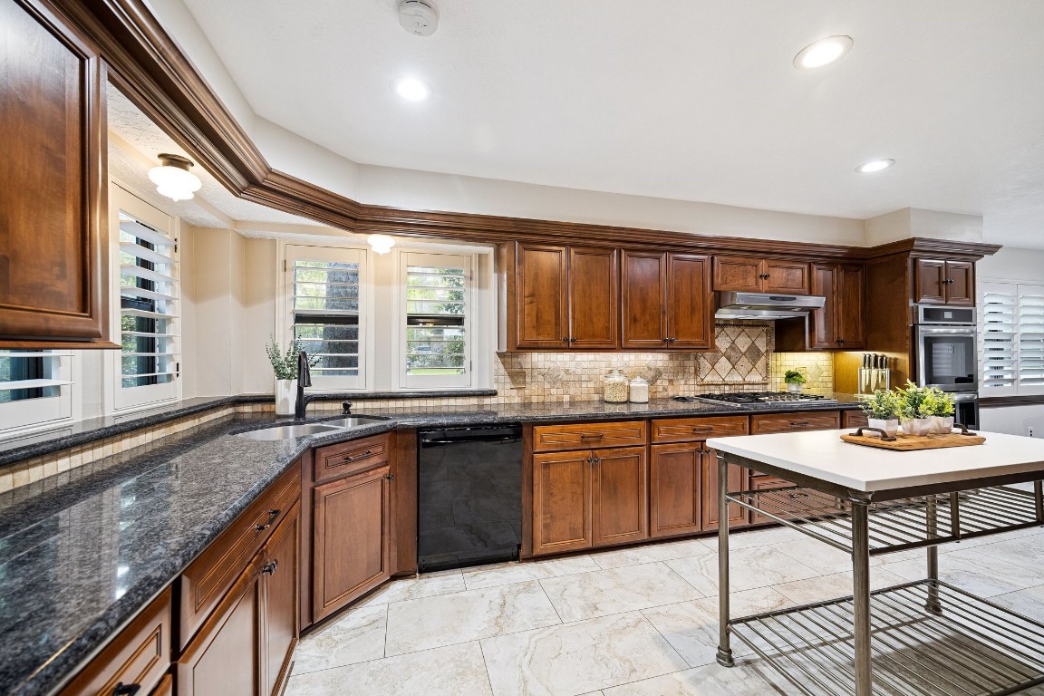2 Chatterbird Spring, TX 77380 - Photo 11 of 40 a kitchen with stainless steel appliances granite countertop a stove top oven a sink dishwasher and cabinets with wooden floor