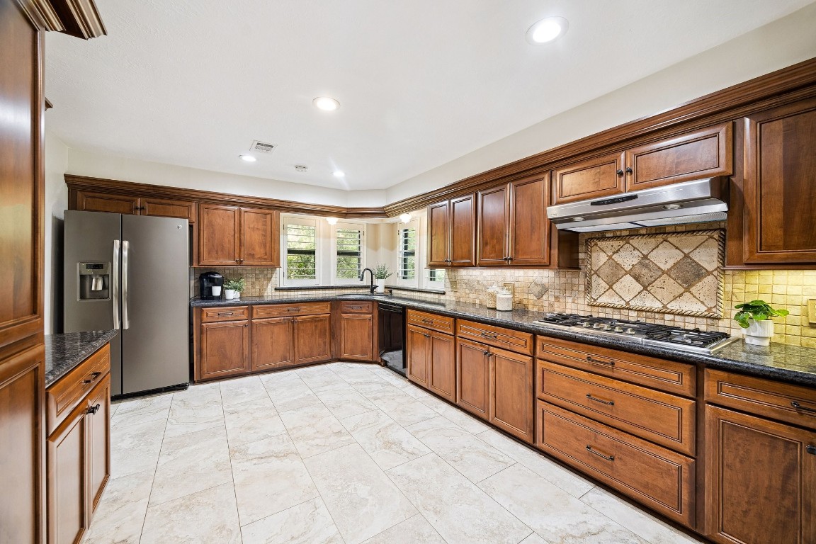2 Chatterbird Spring, TX 77380 - Photo 13 of 40 a large kitchen with stainless steel appliances granite countertop a sink and cabinets