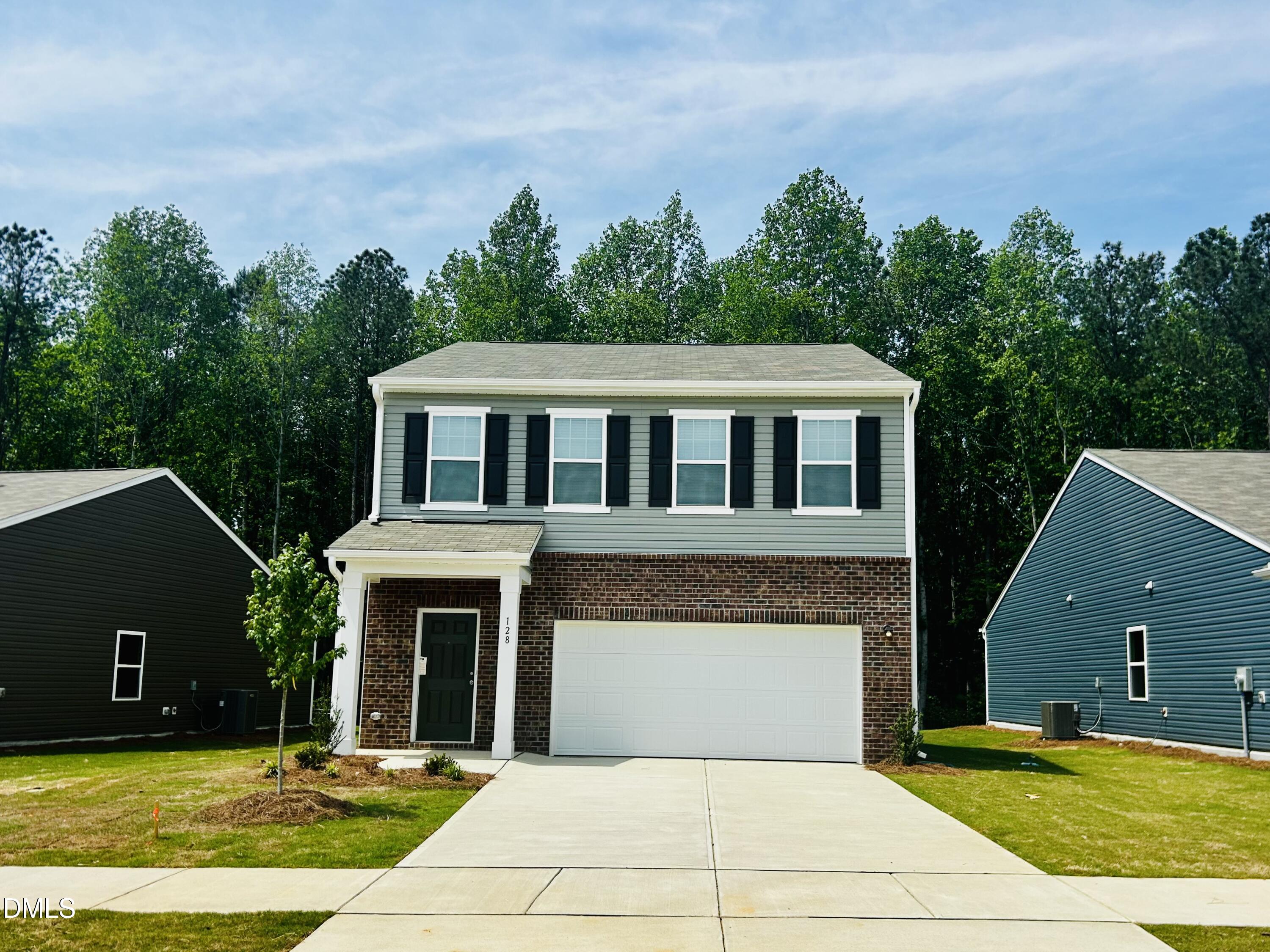111 Valvanos Way Wilson's Mills, NC 27520 - Photo 1 of 32 a front view of a house with garage