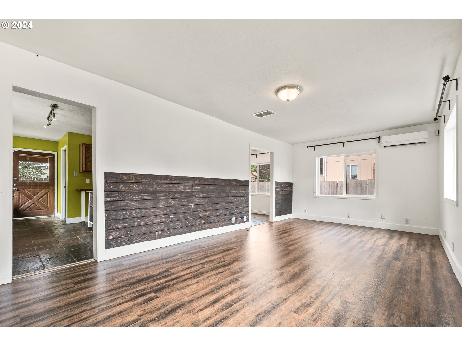 3712 R Street Vancouver, WA 98663 - Photo 4 of 30 a view of an empty room with a window and wooden floor