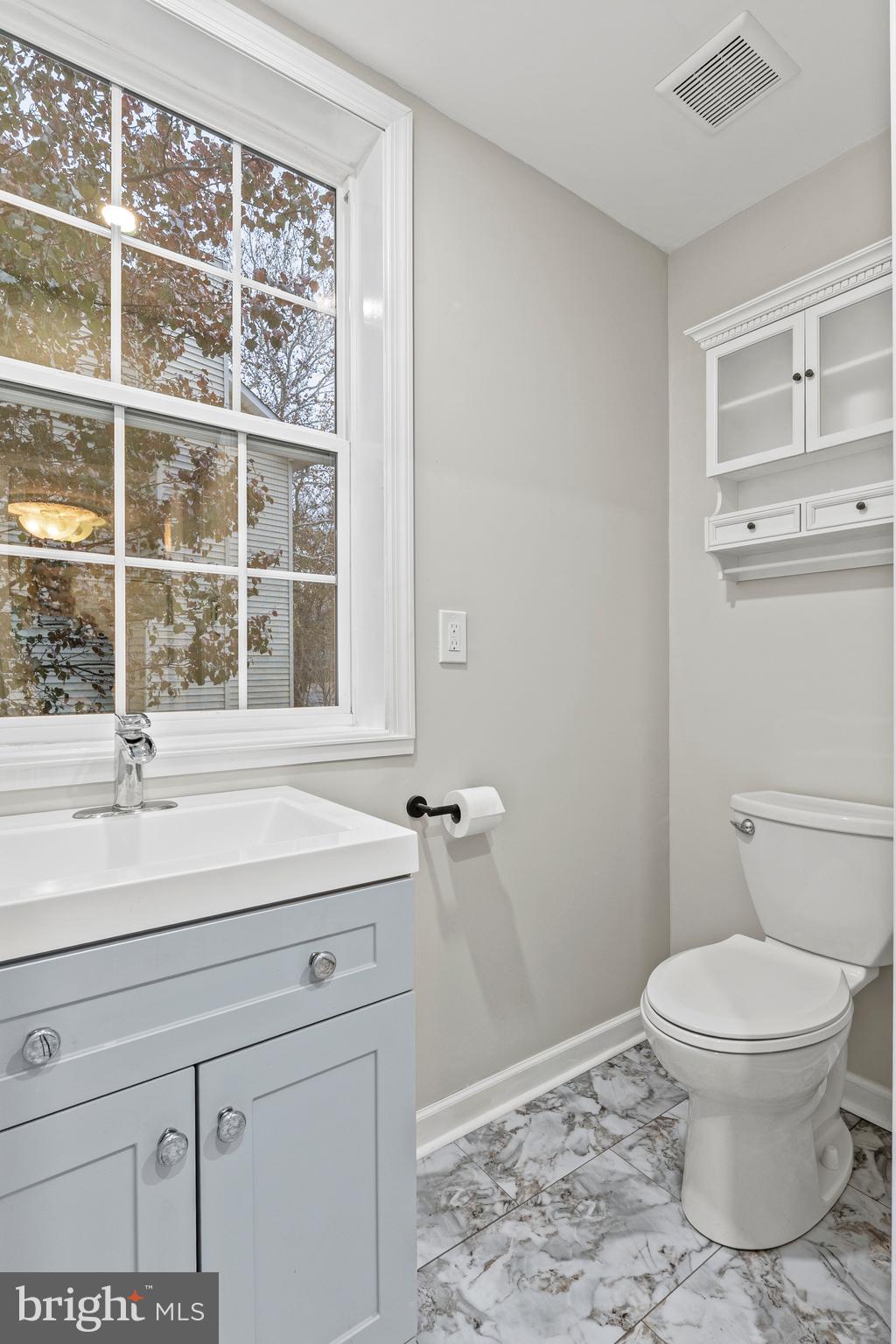 75 Silopanna Road Annapolis, MD 21403 - Photo 16 of 33 a bathroom with a sink a toilet and a window