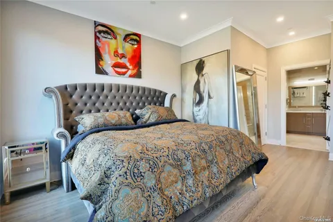 a bed sitting in a bedroom next to a bathroom