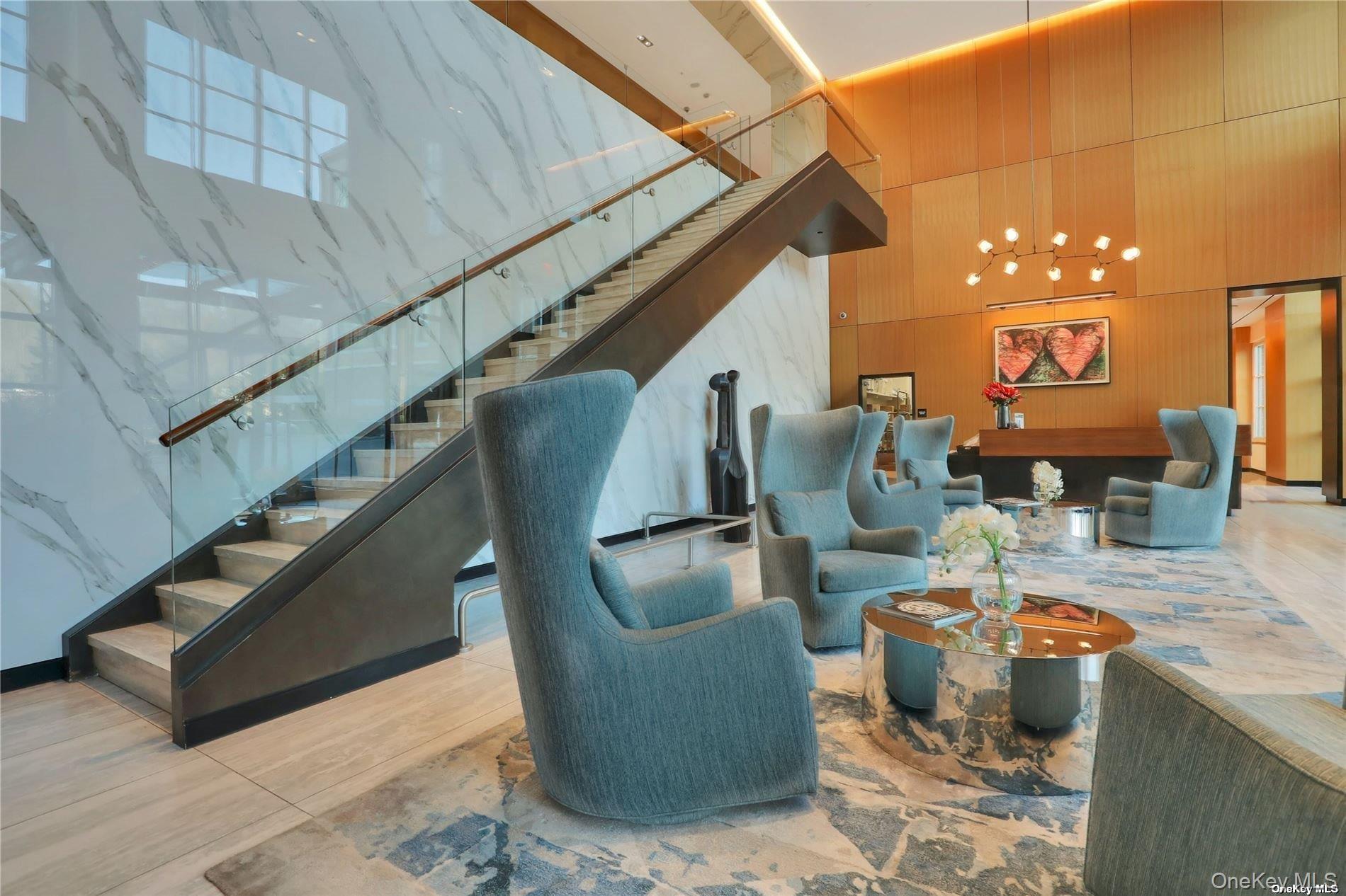 100 Garvies Point Road, Unit 1327 Glen Cove, NY 11542 - Photo 5 of 20 a living room with furniture and wooden floor