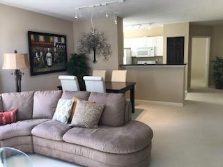 651 Okeechobee Boulevard, Unit 611 West Palm Beach, FL 33401 - Photo 1 of 9 a living room with furniture and a large window